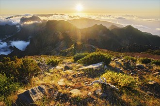 View of mountains over clouds from Pico Ruivo on sunset. Madeira island, Portugal, Europe