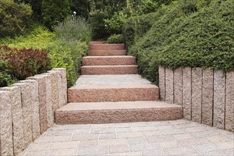 Well-kept front garden with block steps, ornamental stones and planting