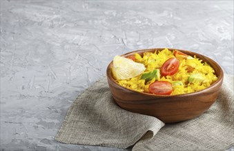 Fried pomelo with tomatoes and avocado in wooden plate on gray concrete background. side view, copy