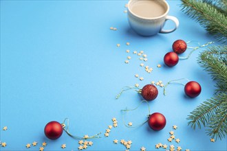 Christmas or New Year composition. Decorations, red balls, fir and spruce branches, cup of coffee,