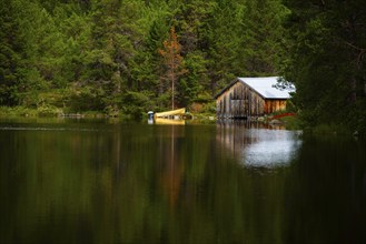 Boats lying on the shore next to a boathouse on a lake, Landscape, Landscape format, Water