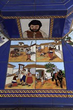 Ceramic tiles on street furniture seat scenes from Cervantes Don Quixote story, Algeciras, Spain,