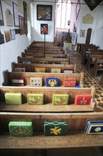 Knitted kneelers on pews, Church of Saint Gregory, Hemingstone, Suffolk, England, UK