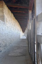 Covered long walkway of the historic town fortifications, town wall, interior view, vanishing