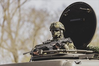 A Czech soldier drives through a forest as part of the military exercise 'Wettiner Schwert' with