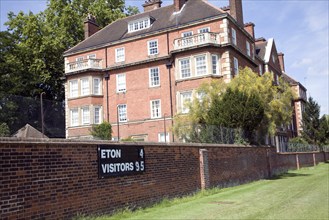 Scoreboard on playing field wall near boarding house of Eton College, Berkshire, England, United