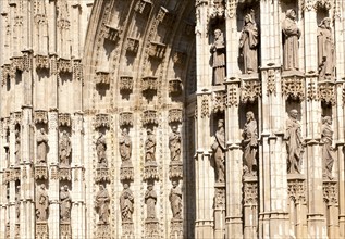 Detail of carved stonework of cathedral frontage showing statues of saints, Seville, Spain, Europe