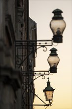 Silhouette of historic street lamps or street lanterns in the evening light, nostalgic atmosphere,