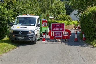 Road Closed sign due to BT maintenance work in street, Shottisham, Suffolk, England, UK