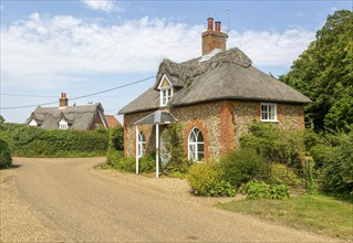 Flint and thatched historic country cottages former estate worker's home, Sutton, Suffolk, England,