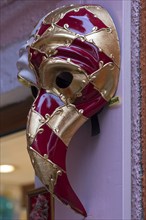 Venetian carnival mask in front of a shop, Burano, Veneto, Italy, Europe