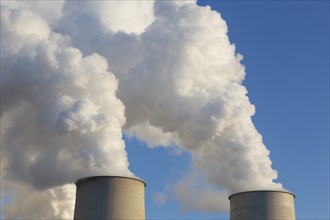 Steam rises from the cooling towers of the Vattenfall power plant in Jänschwalde, power lines and