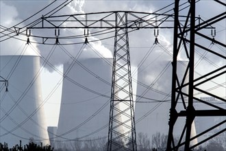 Steam rises from the cooling towers of the Vattenfall power plant in Jänschwalde, power lines and