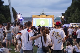 Fassball fans celebrate and gather information in the fan zone at the Brandenburg Tor after the