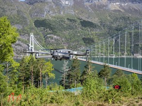 Drone flying near the Hardanger suspension bridge, bridge Hardangerbrua over the Hardangerfjord,