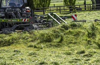 Tractor, mowing grass, turning the grass, near Issum, Lower Rhine, North Rhine-Westphalia, Germany,