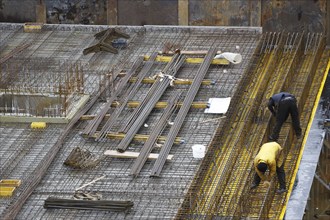 Construction site, reinforced concrete reinforcement bars, for a building ceiling, are installed