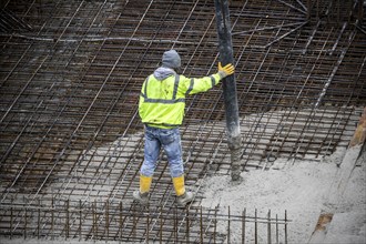 Construction site, concreting, the foundation of a building is concreted, the concrete is pumped