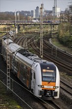 RRX, Rhine-Ruhr-Express train on the railway line between Mülheim an der Ruhr, in the background