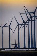 Windmill Poldermolen De Goliath stands between the high-tech wind turbines in Eemshaven, historic