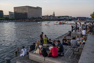 Summer evening in Copenhagen, at the harbour, Islands Brygge, people celebrating, eating, drinking,