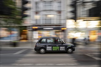 Black taxi with printed advert, wipe-clean image, London, London region, England, United Kingdom,