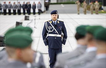 An air force soldier of the guard battalion gives commands to army soldiers of an honour formation