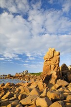 Striking orange-coloured rock formations in the evening light, on the coast of the English Channel