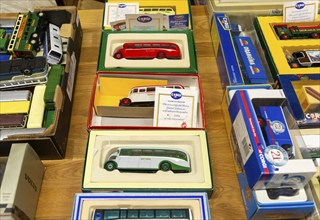 Boxes of Corgi model buses, coaches and other vehicles on display at auction, UK