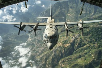 View from an open cargo hatch of a military transport aircraft onto a Hercules C-130 transport