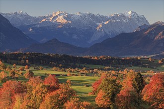 Pre-Alpine landscape with autumnal coloured trees in front of mountains, Riegsee, behind Zugspitze