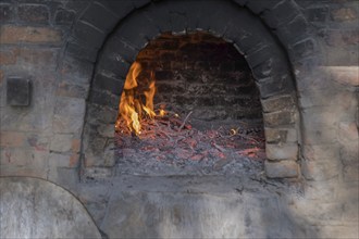 Firing up a traditional bread oven, Münsterland, North Rhine-Westphalia, Germany, Europe