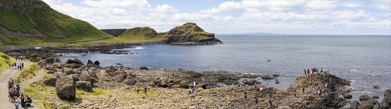 Panoramic view of coast with basalt columns, cliffs and sea under a cloudy sky, Giant Causeway