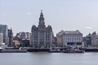 Central building with historic details on a river, Liverpool