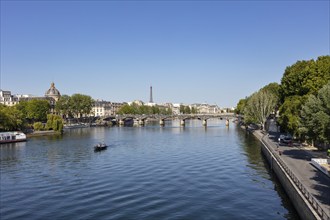 Wide view over a river with several bridges and the Eiffel Tower in the background, Paris