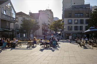 People sitting in a street café in the city in a relaxed atmosphere, Paris