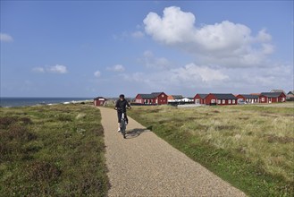 Woman, senior citizen cycling through Jutland in Denmark