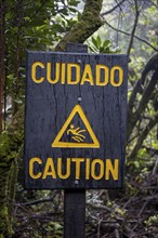 Warning sign Cuidado Caution, Attention danger of slipping, in the forest, Poás National Park,