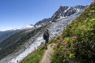 Hiking on the trail to La Jonction, Glacier des Bossons, behind the summit of the Aiguille du Midi,