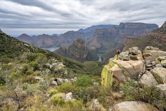 Young man standing on a rock, view of Blyde River Canyon, Upper Viewpoint, canyon landscape,