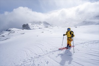 Ski tourers in a snowy mountain landscape, ascent to the Wildhorn, cloudy mood, high tour, Bernese