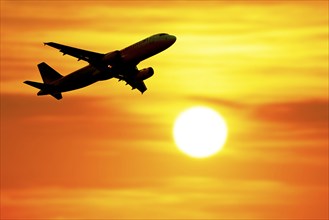 Photomontage, Departing passenger plane in front of the sun, Baden-Württemberg, Germany, Europe