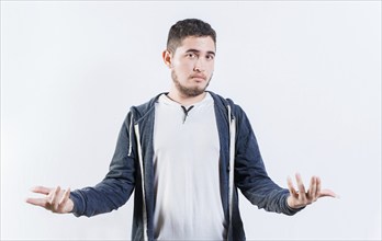 Puzzled person spreading hands isolated. Clueless young man with open arms