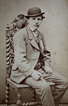 Photo of a man in a suit and bowler hat, sitting on a chair, Carte de Visite, 1890, Historical,