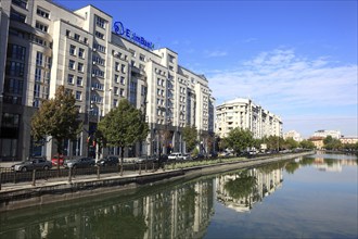 Apartment blocks and office buildings, bank building on the Dambovita River, Bucharest, Romania,