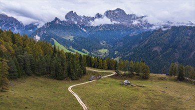 Alpine meadow Wuhnleger, behind the peaks of the rose garden, shrouded in fog, drone shot,