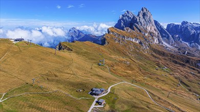 Sofie hut, behind the peaks Sas Rigais and Furchetta of the Geisler group, drone shot, Val Gardena,