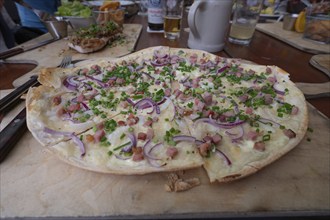 Alsatian-style tarte flambée with bacon and onions, served in a beer garden, Franconia, Bavaria,