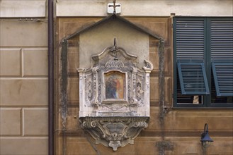 A 19th century aedicule with an image of the Virgin Mary in the historic centre, Piazzetta San