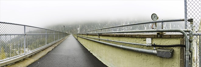 View of the path on the dam wall of the Zufritt reservoir, power station, hydroelectric power plant